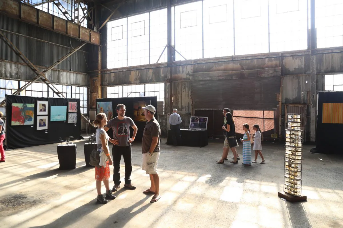 Visitors of the Urban Air Market enjoy the atmosphere in the old workshop building at Pier 70 in the Dogpatch Neighborhood in San Francisco, Calif., on Aug. 18, 2013. (Christian Watjen/Epoch Times)