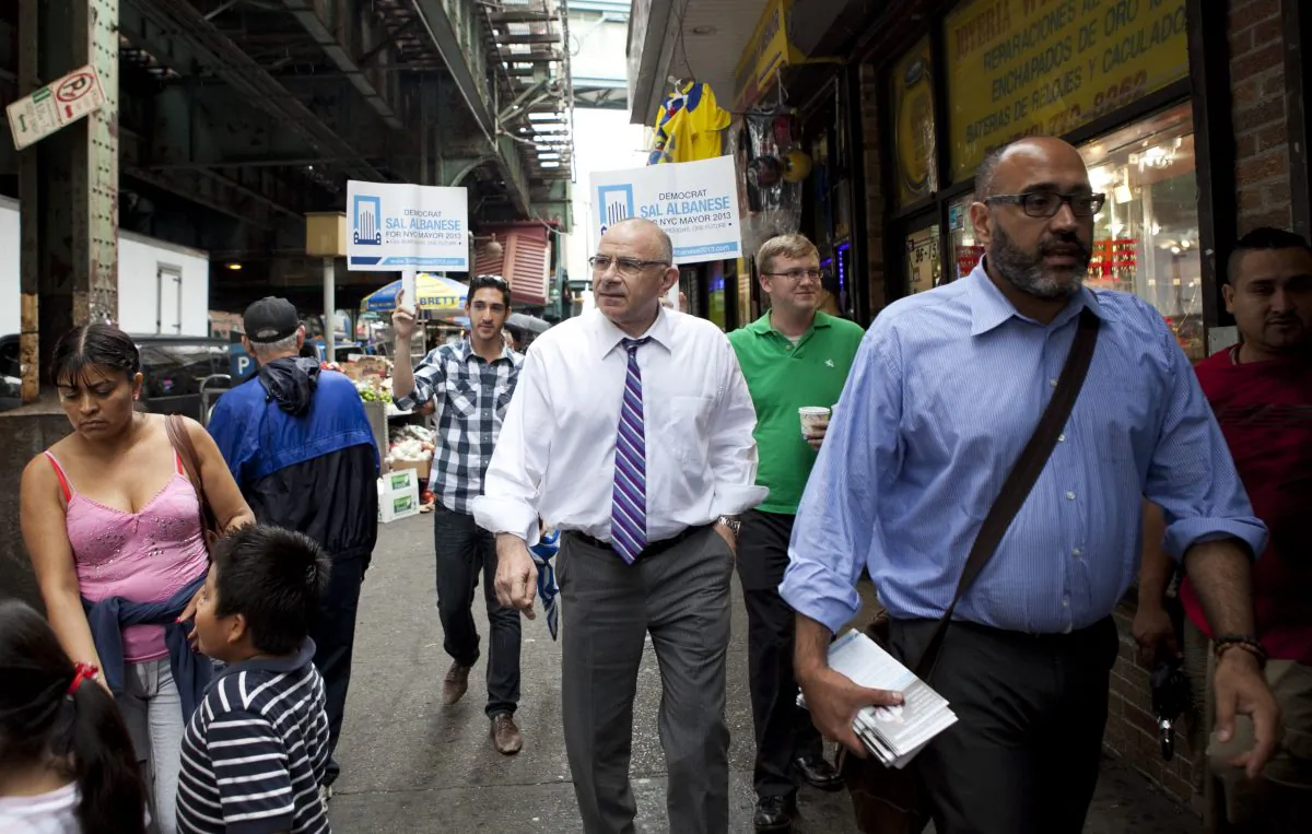 Democratic mayoral candidate Sal Albanese (center) is flanked by members of his campaign while walking down Roosevelt Avenue on August 1, 2013 in Queens, New York. Few people recognize the political independent, who is considered a longshot at this point in the mayor's race, leading up to the September 10 primary. (Samira Bouaou/Epoch Times)