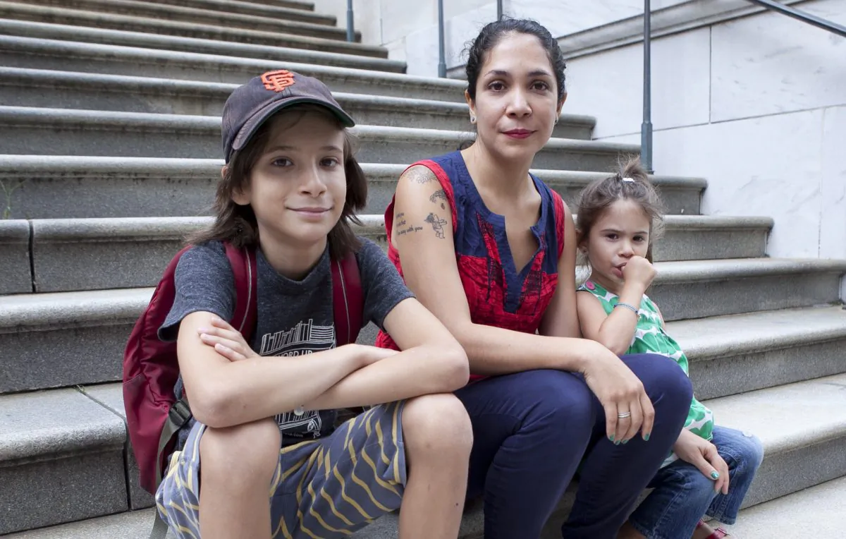 Former teacher and member of Change the Stakes Diana Zavala with her two children Jackson, 10 and Simona, 5 in front of the Tweed Courthouse, Aug. 7. (Samira Bouaou/Epoch Times)