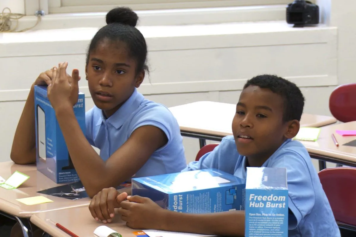 Two 7th grade students in Harlem’s Community Action School, MS 258 listen to a presentation about internet security in New York City, Aug. 28, 2013. Mayor Bloomberg joined the classroom to announce the launch of the EveryoneOn NY initiative that will bring Internet to low-income families. (Ben Hedges/ NTD)