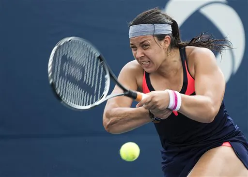 Marion Bartoli, of France, returns the ball against Magdalena Rybarikova, of Slovakia, during the Rogers Cup women's tennis tournament Thursday, Aug. 8, 2013, in Toronto. (AP Photo/The Canadian Press, Nathan Denette)