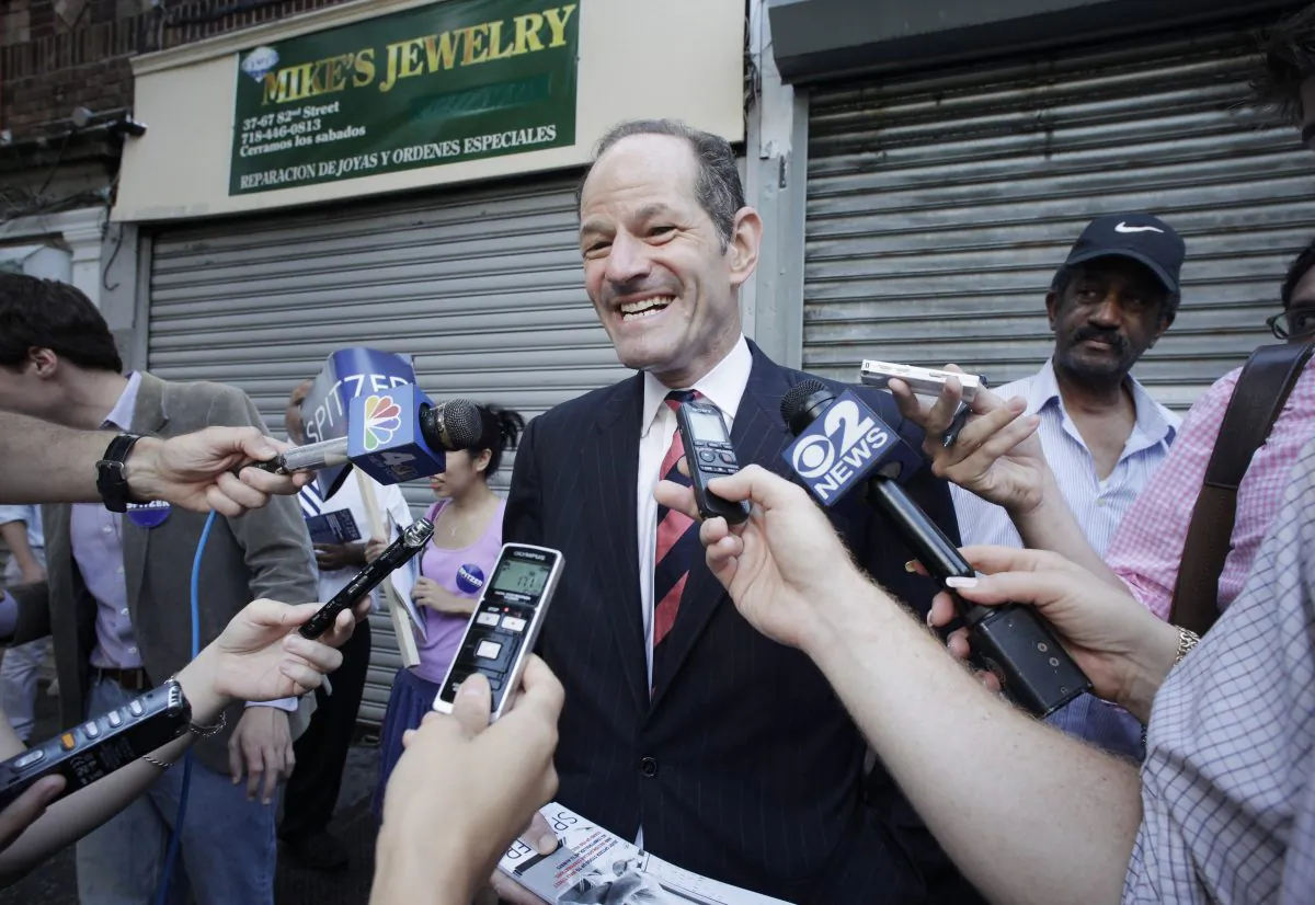 Eliot Spitzer, center, a candidate for New York City comptroller, talks with members of the media as he campaigns in the Jackson Heights neighborhood of the Queens borough of New York, Tuesday, July 23, 2013. (AP Photo/Mark Lennihan)