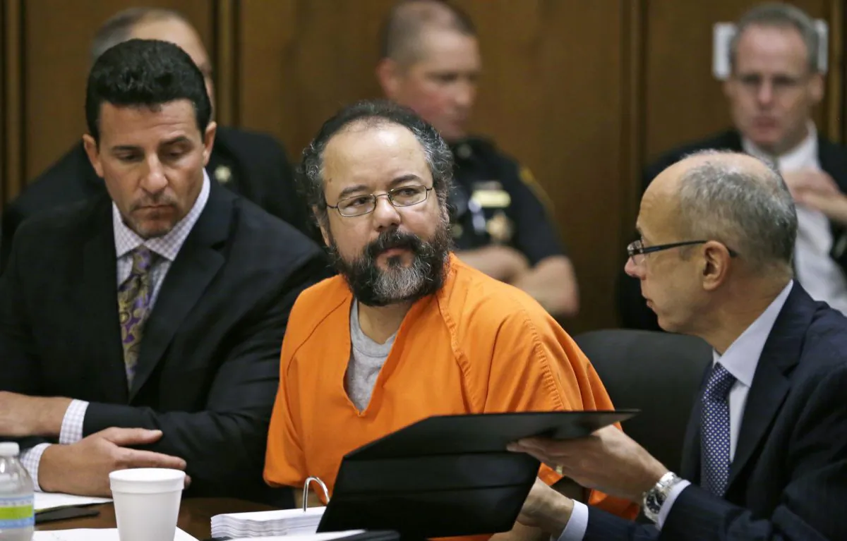 Ariel Castro, center, listens in the courtroom during the sentencing phase Thursday, Aug. 1, 2013, in Cleveland. Defense attorney's Craig Weintraub, left, and Jaye Schlachet sit beside Castro. (AP Photo/Tony Dejak)