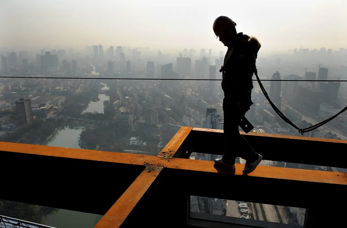 A Chinese worker makes his way along a beam at a construction project in Hefei, east China's Anhui province on April 14, 2011. Despite policy attempts to take some steam off the housing market, property prices have continued to grow. (STR/AFP/Getty Images)
