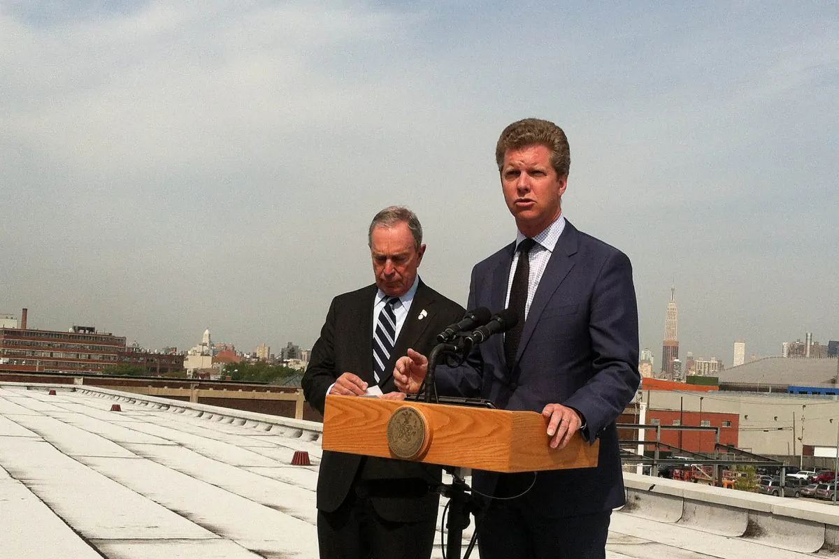 HUD Secretary Shaun Donovan speaks on a rooftop in Greenpoint, Brooklyn, Aug. 19, as Mayor Michael Bloomberg looks on. (Kristen Meriwether/Epoch Times)