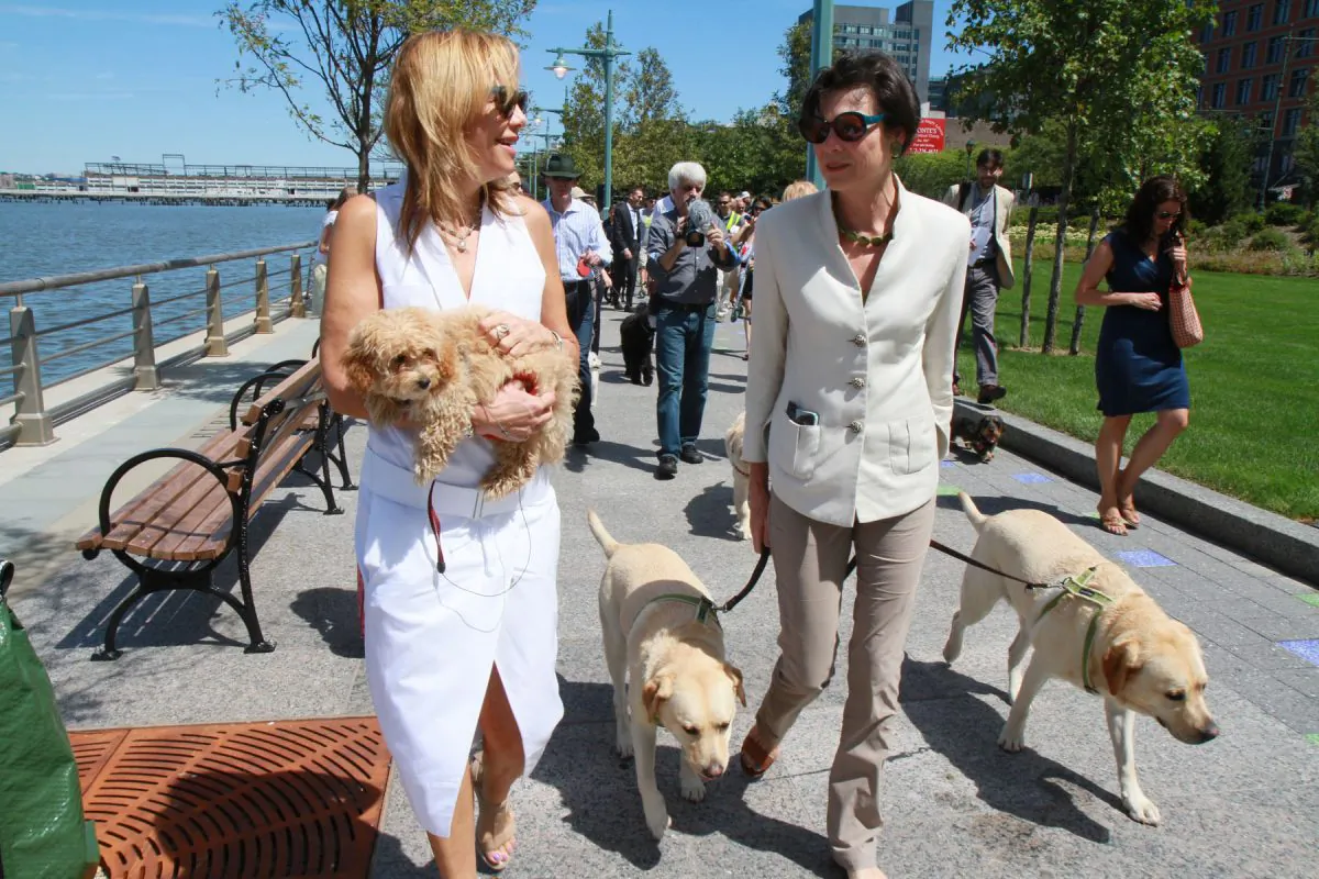 Madelyn Wils (L), President and CEO of Hudson River Park Trust, and Diana Taylor (R), chair of the board of directors of Hudson River Park Trust, walk with their dogs toward the newly opened dog park between North Moore and Hubert Streets in Lower Manhattan on August 5, 2013. (Ivan Pentchoukov/Epoch Times)