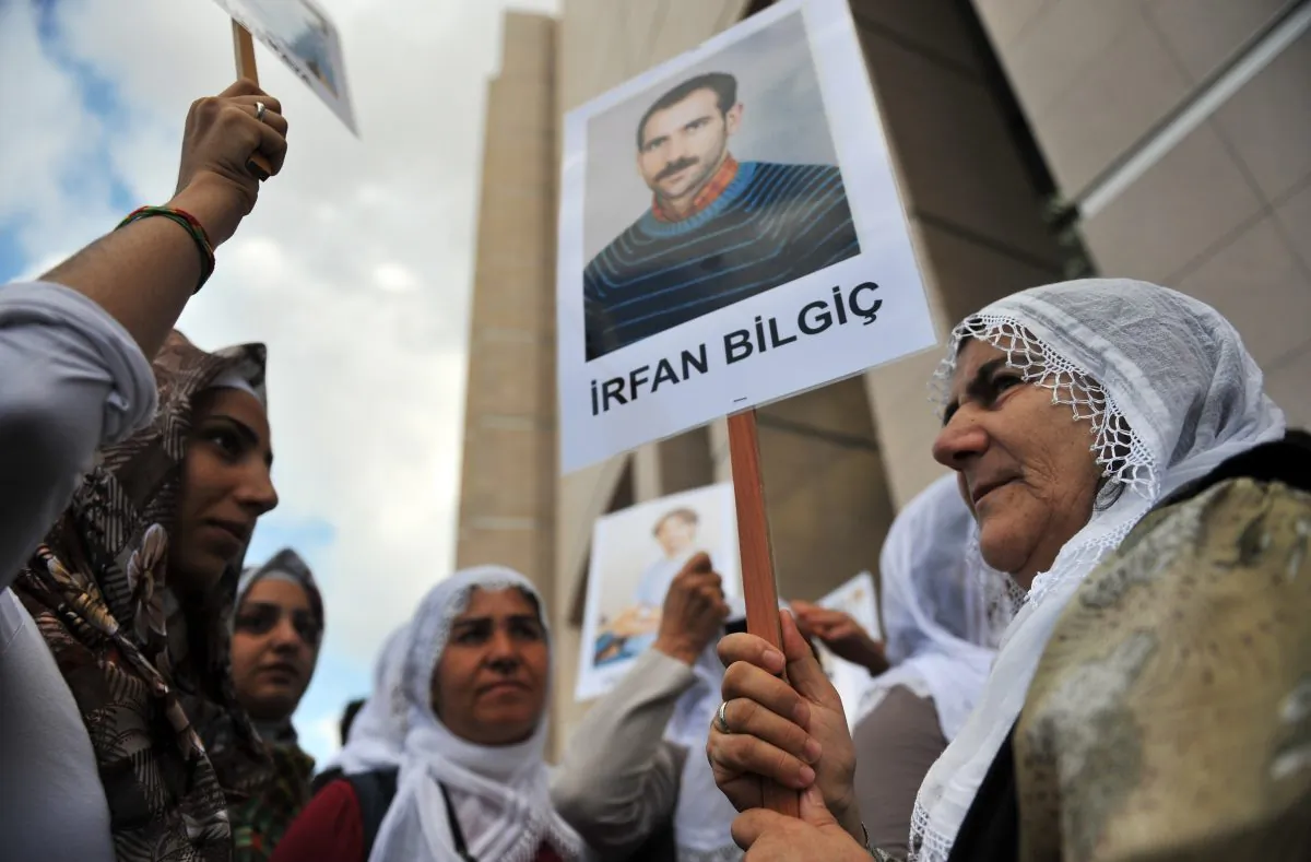 Kurdish women hold pictures of jailed journalists in Istanbul on Sept. 10, 2012. (Bulent Kilic/AFP/GettyImages)