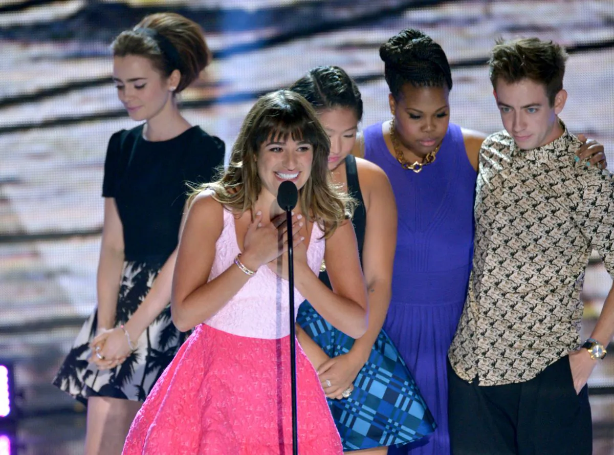 Actress Lea Michele (C) from "Glee"speaks on stage as she accepts an award at the Teen Choice Awards at the Gibson Amphitheater on Sunday, Aug. 11, 2013, in Los Angeles. Pictured in background are fellow cast members, (R-L) Kevin McHale, Amber Riley, Jenna Ushkowitz and presenter Lily Collins. (John Shearer/Invision/AP)