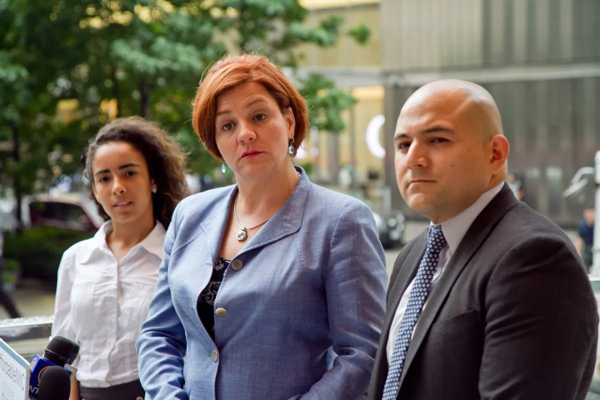 Council Speaker and mayoral candidate Christine Quinn speaks on the steps of Borough of Manhattan Community College on Aug. 1, joined by Bronx Bridges High School principal Pablo Villavicencio and Carmen Pujols, 17, a senior at Bronx Bridges High School. (Joshua Philipp/Epoch Times)