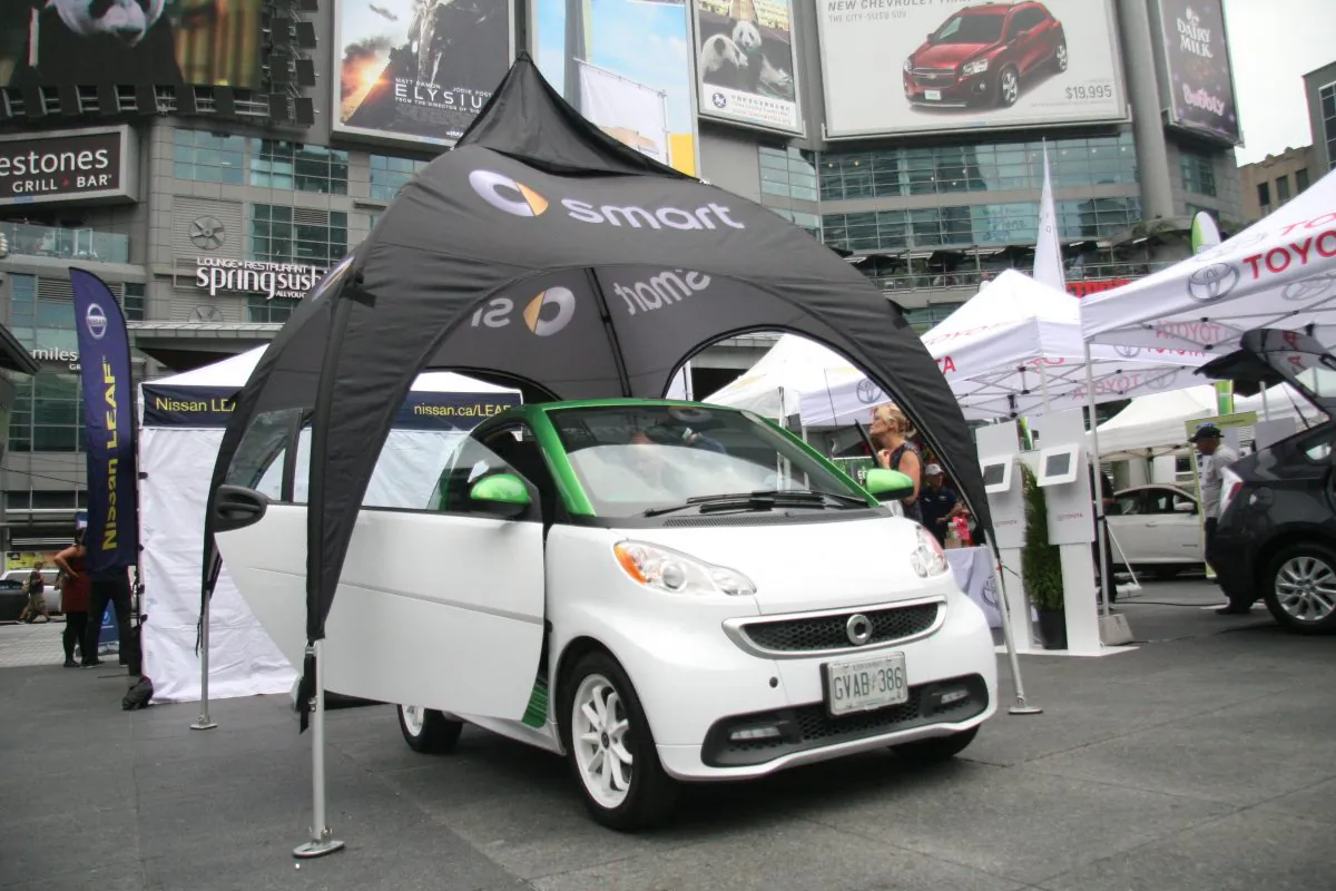 The two-seater electric Smart car was open for inspection during the Plug’n Drive Electrical Vehicle Day event, where visitors could test drive electric vehicles and learn all about them, in Yonge-Dundas Square in downtown Toronto. (Kristina Skorbach/The Epoch Times)