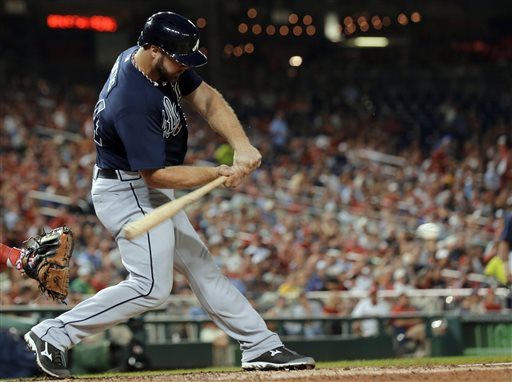 Atlanta Braves' Evan Gattis hits a two-run single during the fifth inning of a baseball game against the Washington Nationals at Nationals Park Tuesday, Aug. 6, 2013, in Washington. (AP Photo/Alex Brandon)