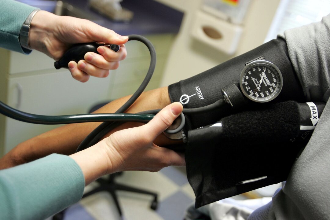 A person is seen using a blood pressure device in a file photo. (Joe Raedle/Getty Images)