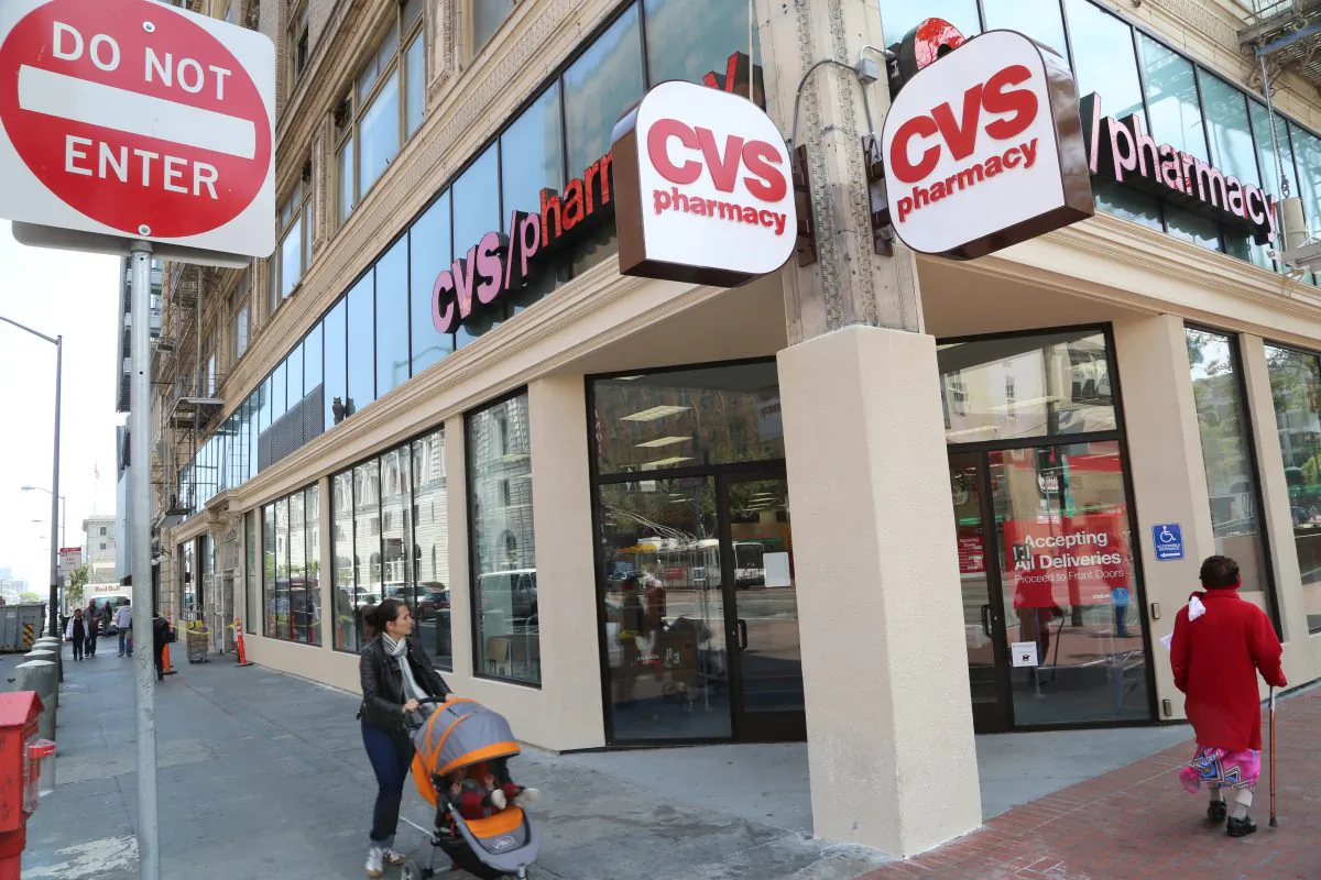 Pedestrians pass by a newly constructed CVS pharmacy at the corner of Market and 7th Streets in San Francisco, July 30, 2013. The chain store, slated to open in mid-August in the South of Market neighborhood, has replaced a check-cashing outlet, cafés, and a liquor store that shut down at the same location. (Christian Watjen/Epoch Times)
