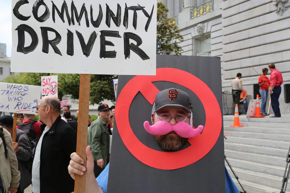 A protestor demanding an end to ride-sharing services at San Francisco City Hall, Calif., July 30, 2013. (Christian Watjen/Epoch Times)