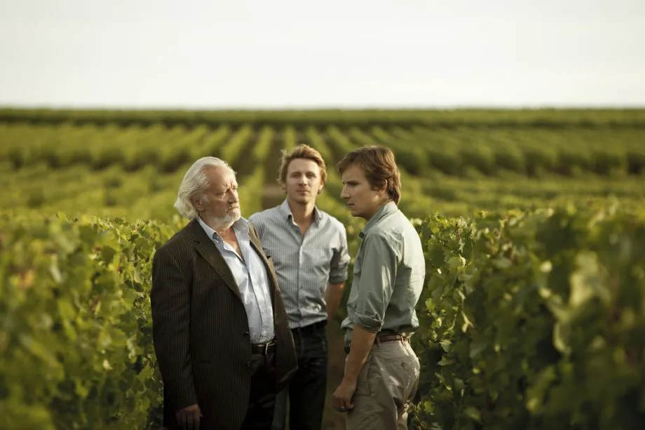 Paul de Marseul (L, played by Niels Arestrup) is a proprietor of a prestigious family wine estate with his son and heir Martin (R, played by Lorànt Deutsch) in the dramatic film “You Will Be My Son.” (Courtesy of Cohen Media Group)
