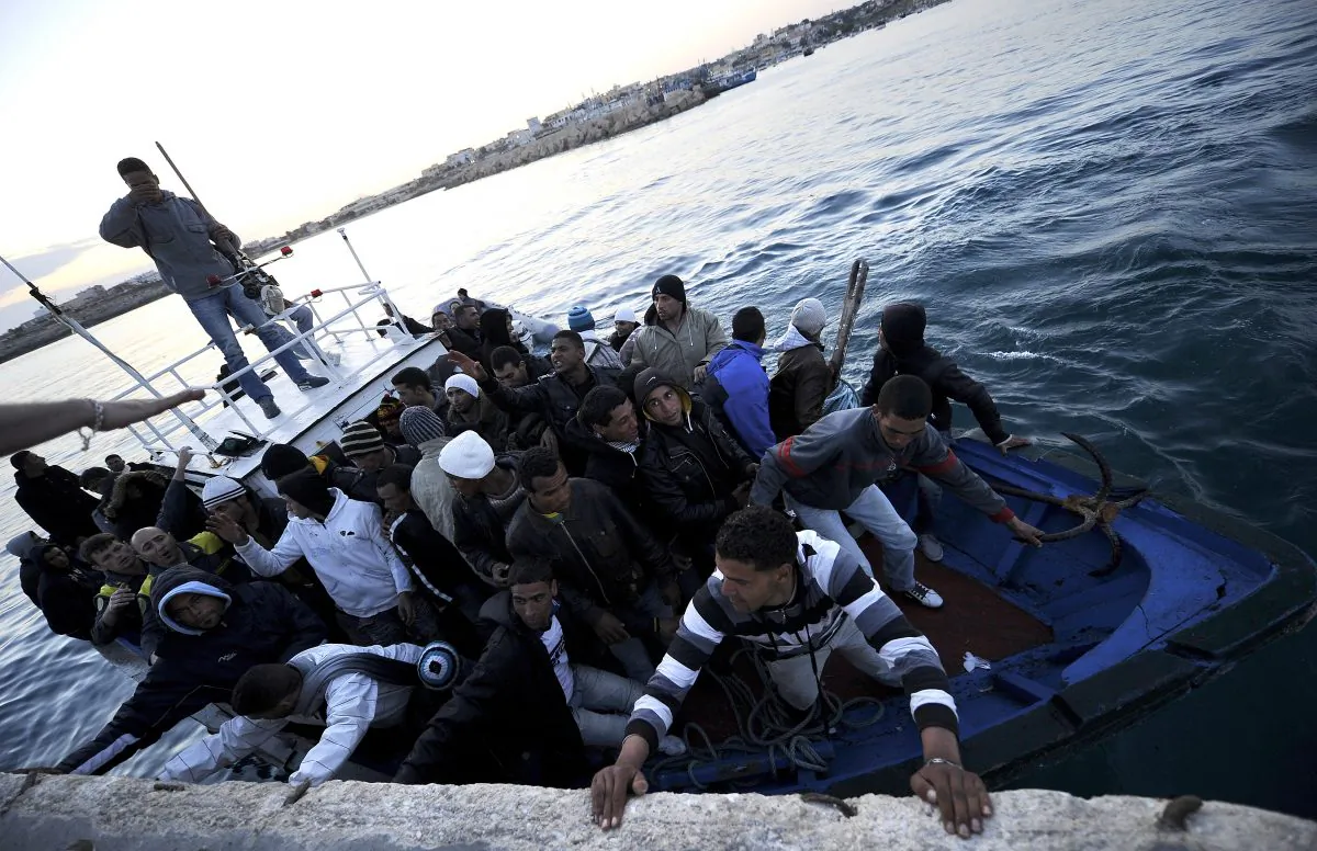 A boat carrying Tunisian migrants enters the port of Lampedusa, Sicily, on April 12, 2011. Sicily is now dealing with an influx of Syrian migrants, as they must pass through Italy on their way to central European countries as they flee violence at home. (Filippo Monteforte/AFP/Getty Images)