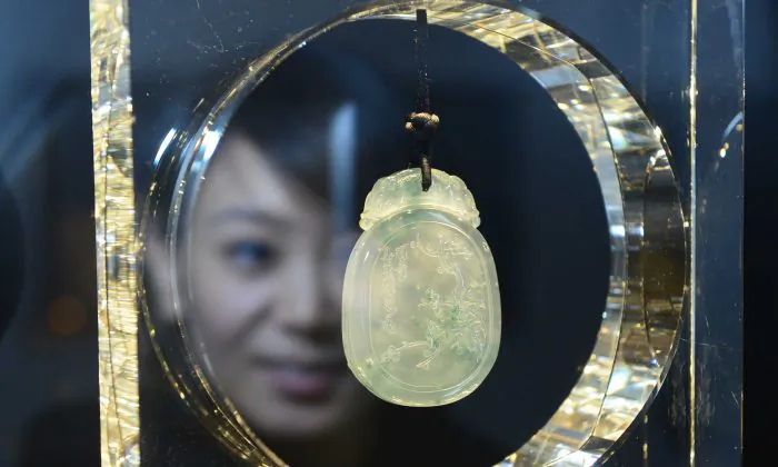 Awoman looking at a piece of jewelry at the China International Jewellery Show in Beijing, Dec. 16, 2012.  (STR/AFP/Getty Images)