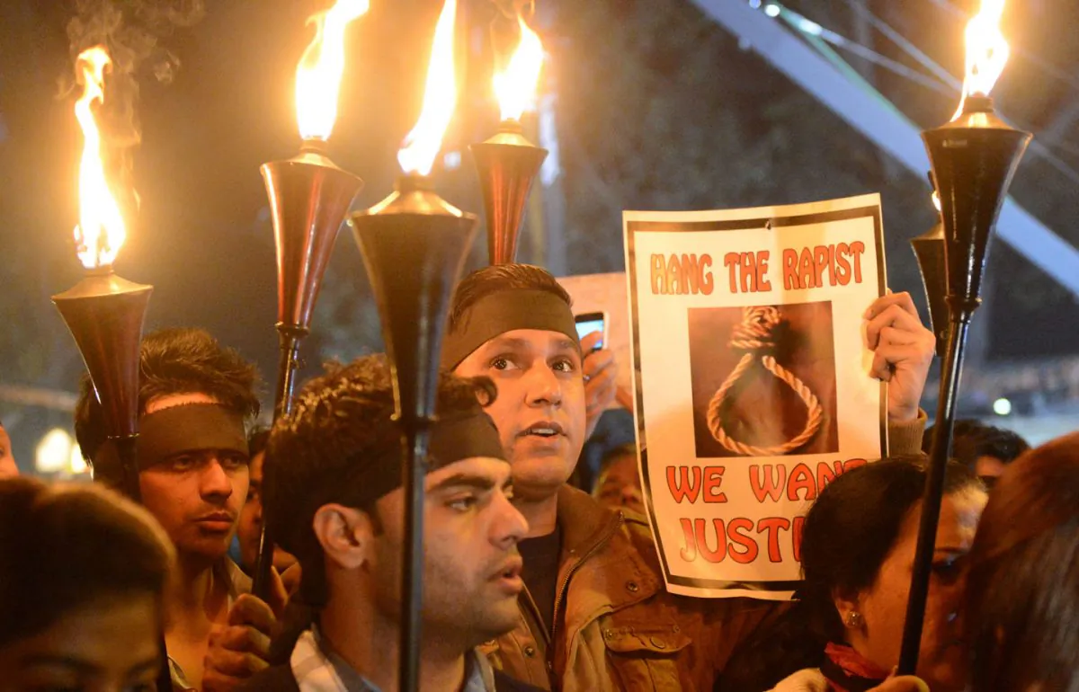 Indian protesters hold torches and placards during a rally in New Delhi on December 29, 2012, after the death of a gang rape student from the Indian capital. An Indian court awarded the four convicted on Tuesday for rape and murder to (RAVEENDRAN/AFP/Getty Images)