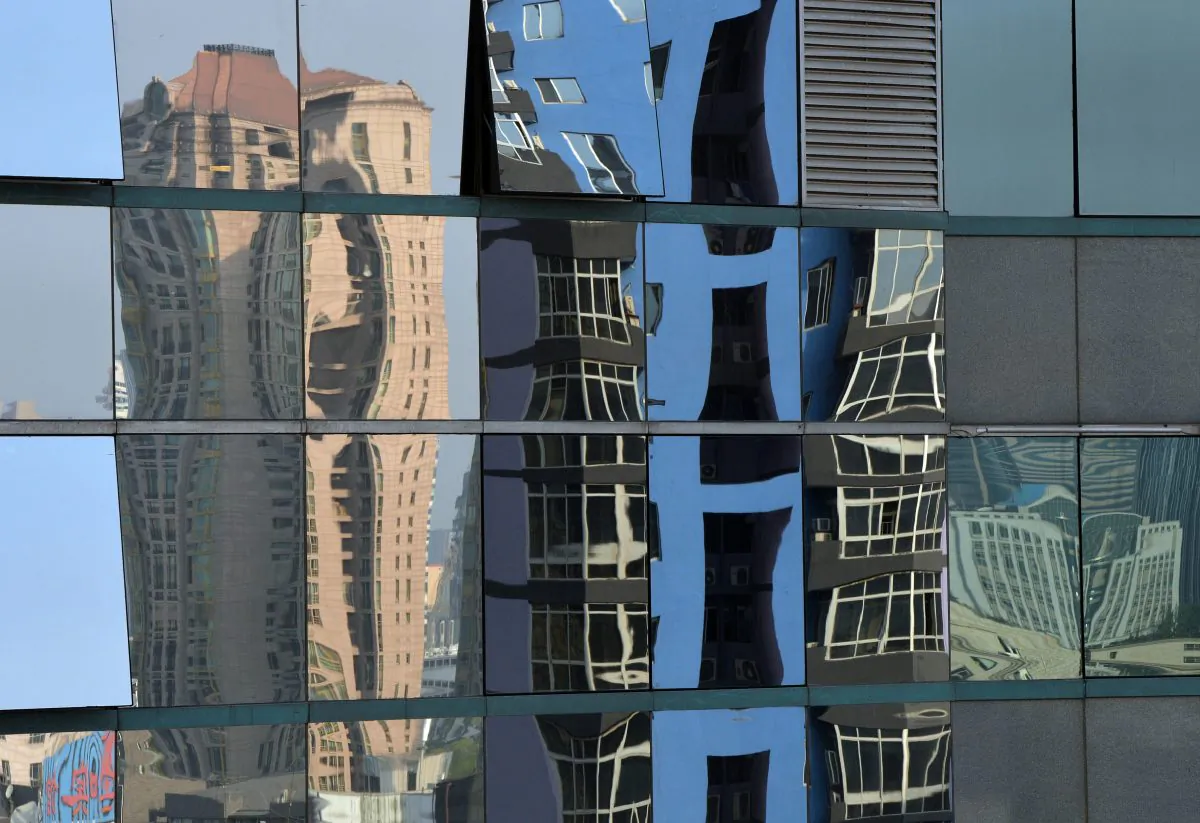 High rise properties are reflected on an office building's windows in Beijing on May 6, 2013. Home prices in Beijing continue to rise, in spite of the awareness that the housing bubble in China will eventually burst. (Mark Ralston/AFP/Getty Images) 