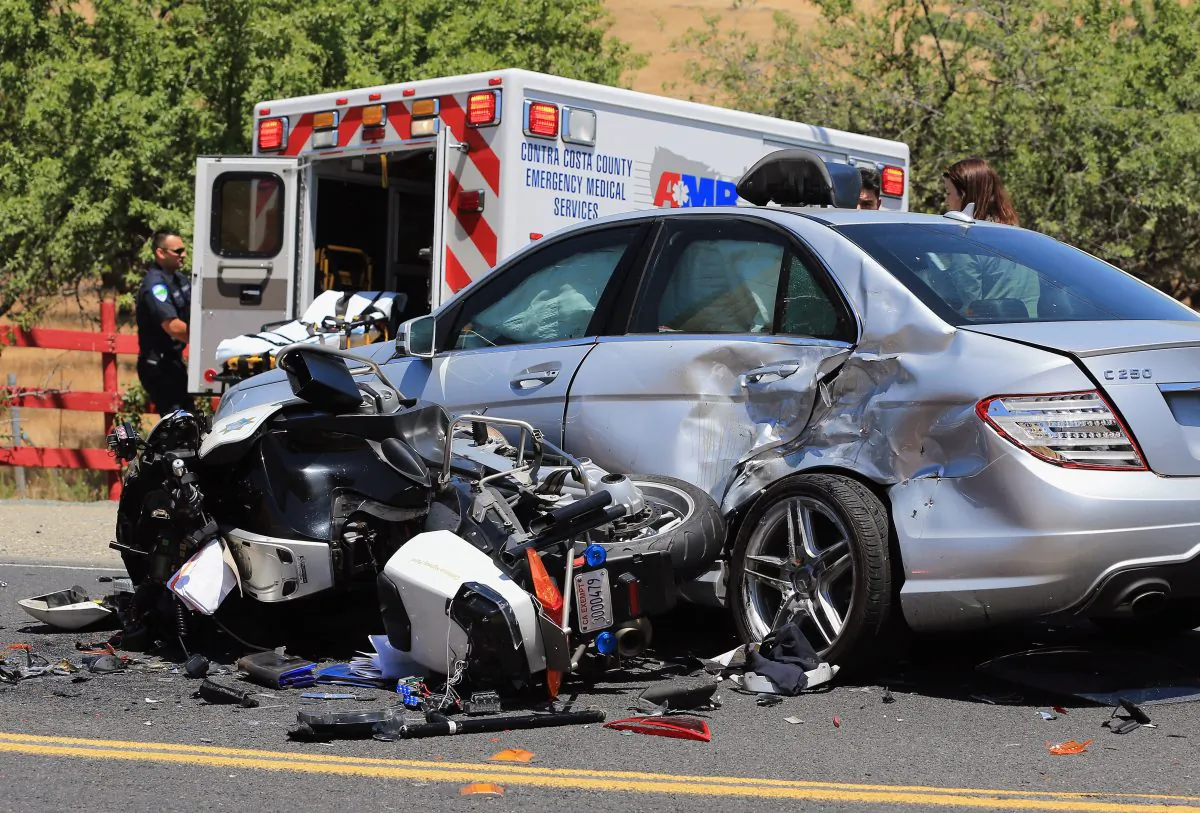 The aftermath of an accident remains in the road after a California Highway Patrol motorcycle officer providing traffic control for a race collided with a car making a u-turn on May 18, 2013, in Brentwood, Calif. The officer was air lifted to the John Muir Medical Center with major injuries. (Doug Pensinger/Getty Images)