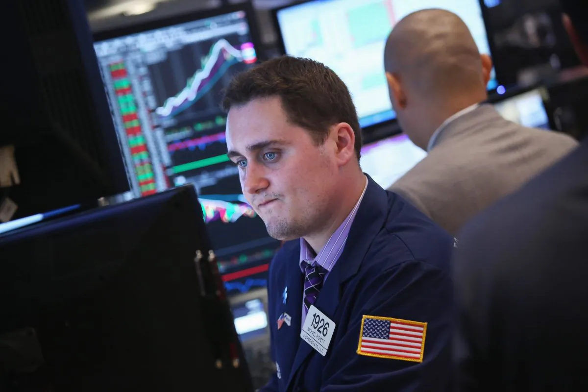  A floor trader works at the New York Stock Exchange at the end of the trading day on Sept. 20. The Dow Jones Industrial Average dropped 185 points to finish Sept. 20 at 15,451. (John Moore/Getty Images)
