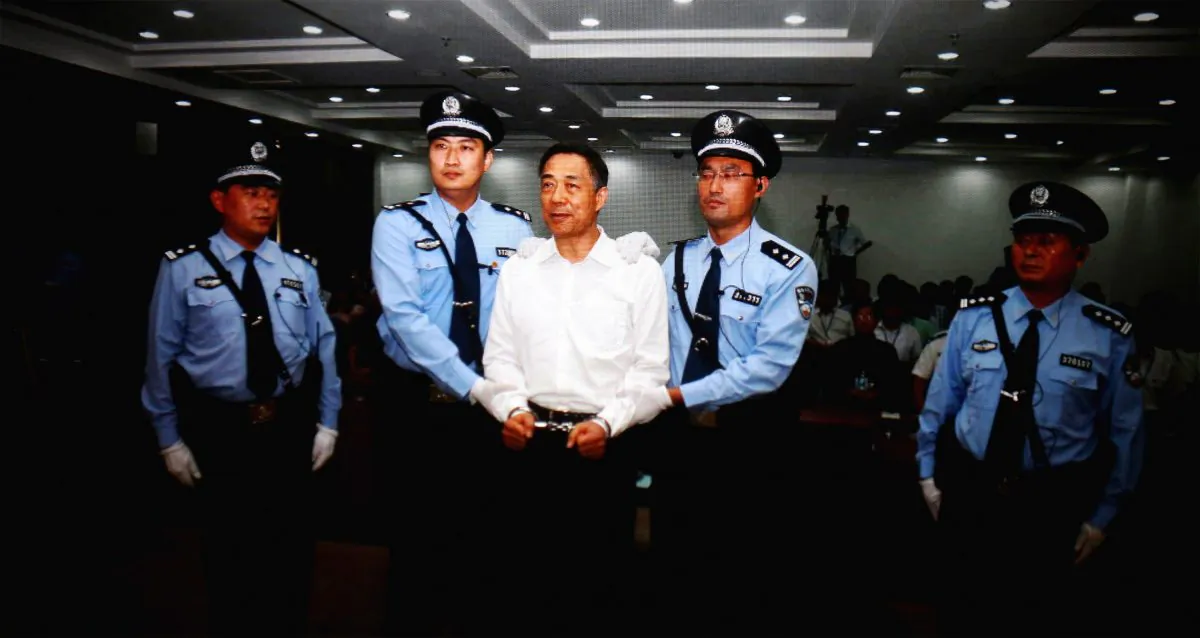 A screen shows the picture of the sentencing of disgraced former Politburo member Bo Xilai (Center) on Sept. 22, 2013 in the Jinan Intermediate People's Court, in Shandong Province, China. Chen Pokong argues Bo's trial was used by Party central to attack two other high-ranking officials. (Feng Li/Getty Images)