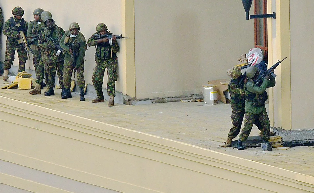 Kenyan soldiers move in formation, clearing the top floor balcony and interior of Westgate Mall on September 24, 2013 in Nairobi. Kenya's President Uhuru Kenyatta said that the terrorists who were inside are defeated. (Carl de Souza/AFP/Getty Images)