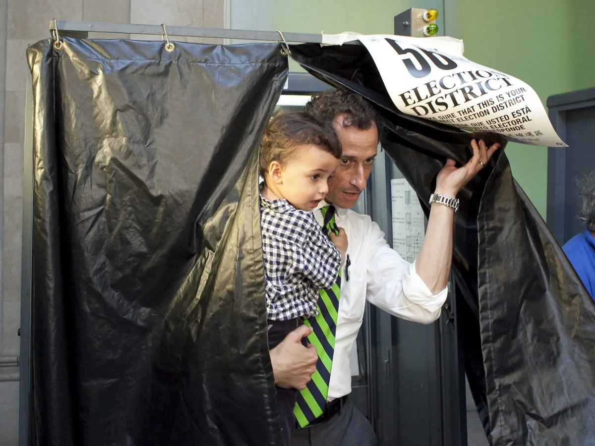 Anthony Weiner and his son Jordan Zain Weiner exit the polling booth on East 22nd Street, New York, Sept. 10, 2013. (Samira Bouaou/Epoch Times)