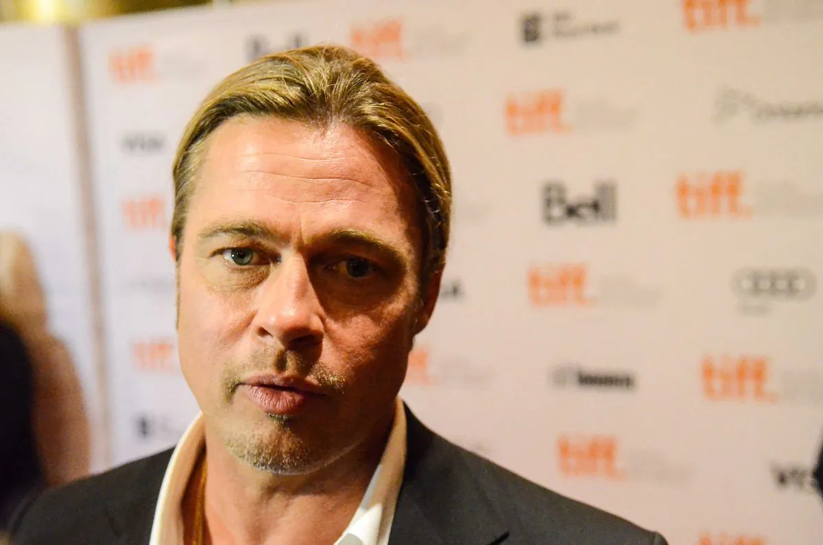 Actor Brad Pitt walks down the red carpet for the premiere of "12 Years a Slave" on Sept. 6, 2013. Pitt, who has an important cameo in the film and helped to secure funding, said the story has a message that people need to hear. (Matthew Little/The Epoch Times)