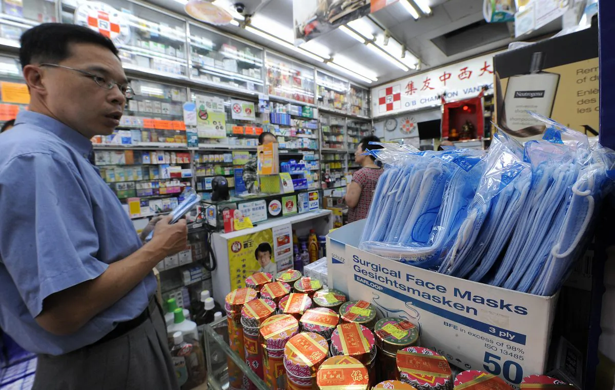 A man checks out the surgical masks for sale at a pharmacy in Hong Kong on April 28, 2009. A swine flu epidemic in mainland China had caused a severe shortage of masks there. Hong Kong citizens fear the current popularity of Hong Kong pharmacies among mainlanders seeking cheaper prices may lead to shortages and rising prices for drugs. (Mike Clarke/AFP/Getty Images)