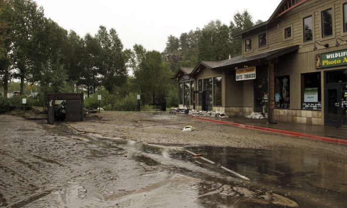 Mud from flooding is shown covering the main street Sunday Sept. 15, 2013 in Estes Park, Colo., after water and debris swamped the town when the Big Thompson River surged through Estes Park late Thursday and early Friday. In Estes Park, some 20 miles from Lyons, hundreds of homes and cabins were empty in the town that is a gateway to Rocky Mountain National Park. High water still covered several low-lying streets. Where the river had receded, it had left behind up to a foot of mud.  (AP Photo/Jeri Clausing)
