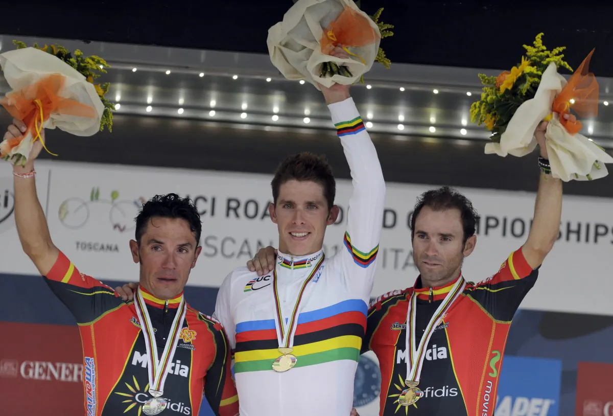 Gold medal's winner Alberto Rui Costa is flanked by silver medalist Joaquin Rodriguez and bronze medalist Alejandro Valverde Belmonte, of Spain, during the podium ceremony for the Men's Elite road race event, at the UCI Road Cycling World Championships, in Florence, Italy, Sunday, Sept. 29, 2013. Costa can manage a smile but Rodriguez is still crying over the deep disappointment of knowing he had the win and lost it through a small error. (AP Photo/Luca Bruno)