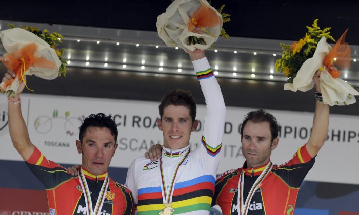 Gold medal's winner Alberto Rui Costa is flanked by silver medalist Joaquin Rodriguez and bronze medalist Alejandro Valverde Belmonte, of Spain, during the podium ceremony for the Men's Elite road race event, at the UCI Road Cycling World Championships, in Florence, Italy, Sunday, Sept. 29, 2013. Costa can manage a smile but Rodriguez is still crying over the deep disappointment of knowing he had the win and lost it through a small error. (AP Photo/Luca Bruno)