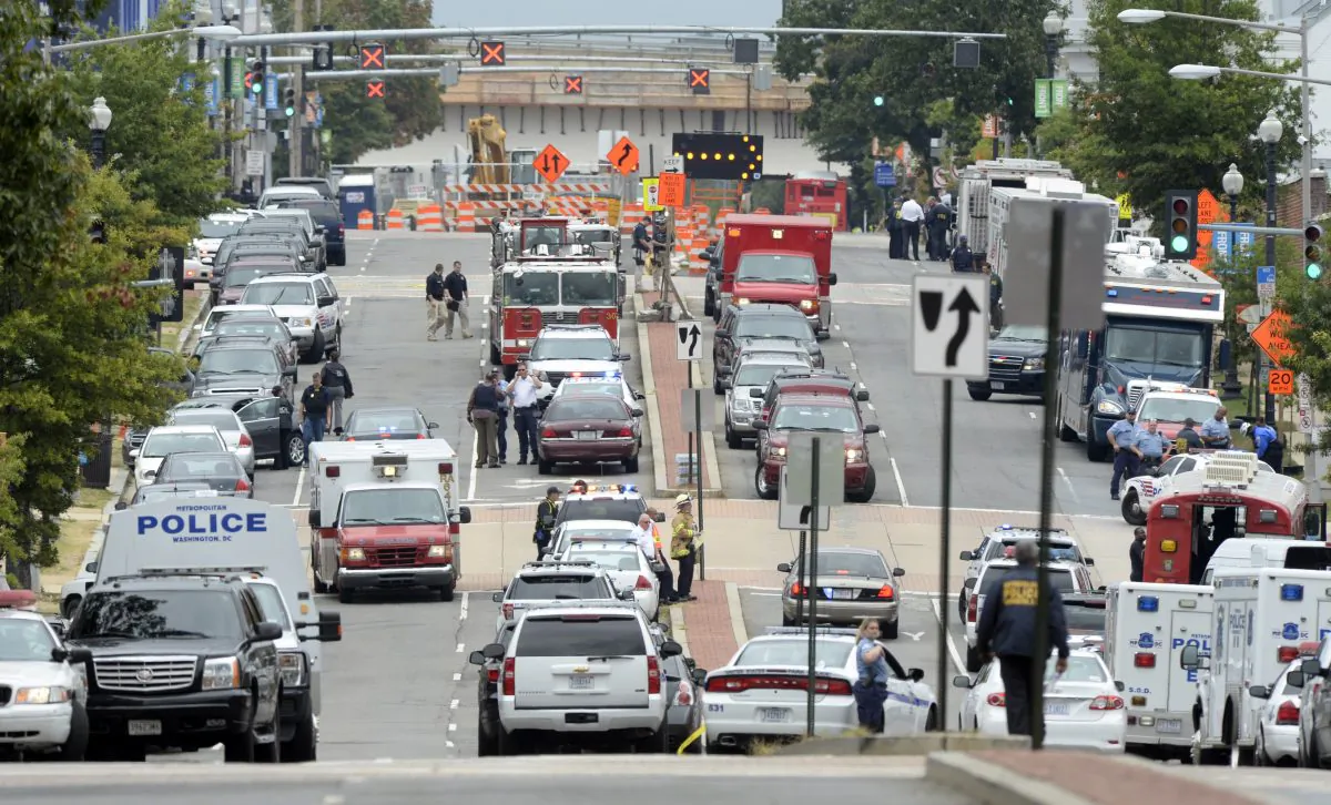 The main street near the Washington Navy Yard is crowded with official vehicles following a shooting at the Washington Navy Yard in Washington, Monday, Sept. 16, 2013. (AP Photo/Susan Walsh)