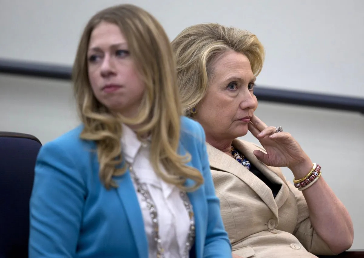 Former Secretary of State Hillary Rodham Clinton sits with her daughter Chelsea before speaking about Syria in the White House in Washington, D.C., Sept. 9, 2013, during a the White House Forum to Combat Wildlife Trafficking. Clinton said any move by Syria to surrender its chemical weapons to international control would be an "important step." (AP Photo/Carolyn Kaster)