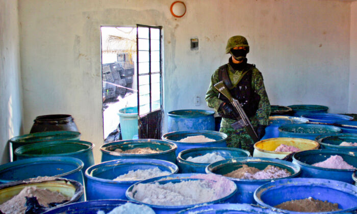 A soldier stands guard inside a clandestine chemical drug processing laboratory discovered in Mexico on Feb. 9, 2012. Chinese gangs are supplying Mexican drug cartels with chemicals to create illicit substances, for sale in the United States. (Hector Guerrero/AFP/Getty Images)