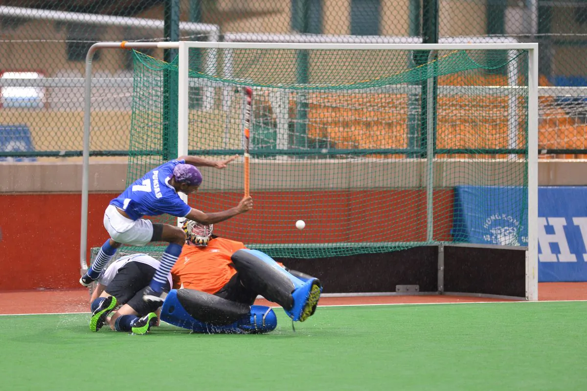 Mohammad Nadeem of Punjab-A made a spectacular finish to his run into the HKFC-B circle lifting the ball over the HKFC goalkeeper to score during their 4-0 win last Sunday Sept 22, 2013. The match was abandoned after five minutes of the second half due to Typhoon Usagi. (Bill Cox/Epoch Times)