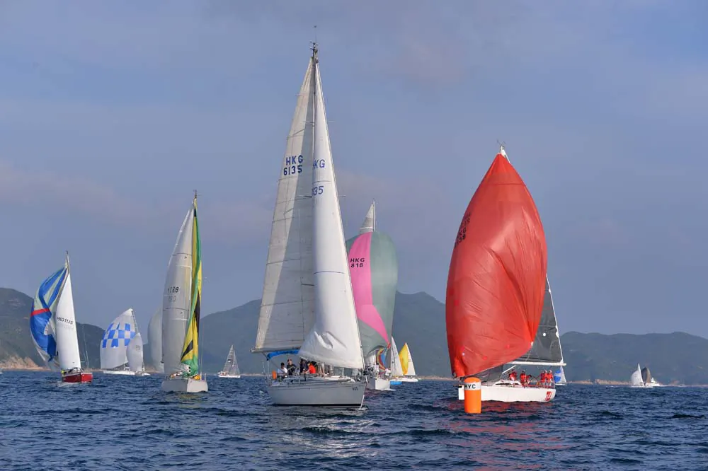 Boats showing a splash of colour as they approach the Leeward mark during Race-2 of the Hebe Haven Yacht Club Port Shelter Regatta on Saturday Sept 14, 2013. (Bill Cox/Epoch Times)