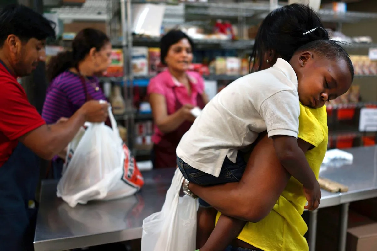 Jaden Painegua, 2, rests on his mother's shoulder at the West Side Campaign Against Hunger food bank on July 24, 2013, in New York City. The food bank assists thousands of qualifying New York residents by providing a monthly allotment of food. (Spencer Platt/Getty Images)
