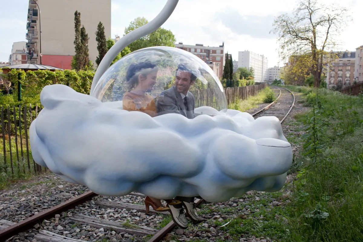 Chloe and Colin, played by Audrey Tautou (L) and Romain Duris, travel in a cloud on a panoramic tour over Paris.