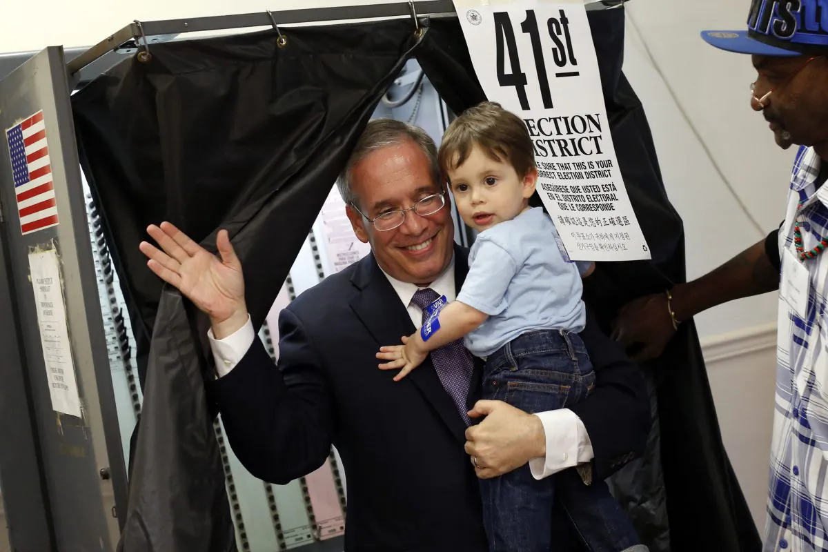 Manhattan Borough President Scott Stringer comes out of a voting booth with his son Max after casting his ballot during the primary election in New York, Sept. 10, 2013. (AP Photo/Jason DeCrow)