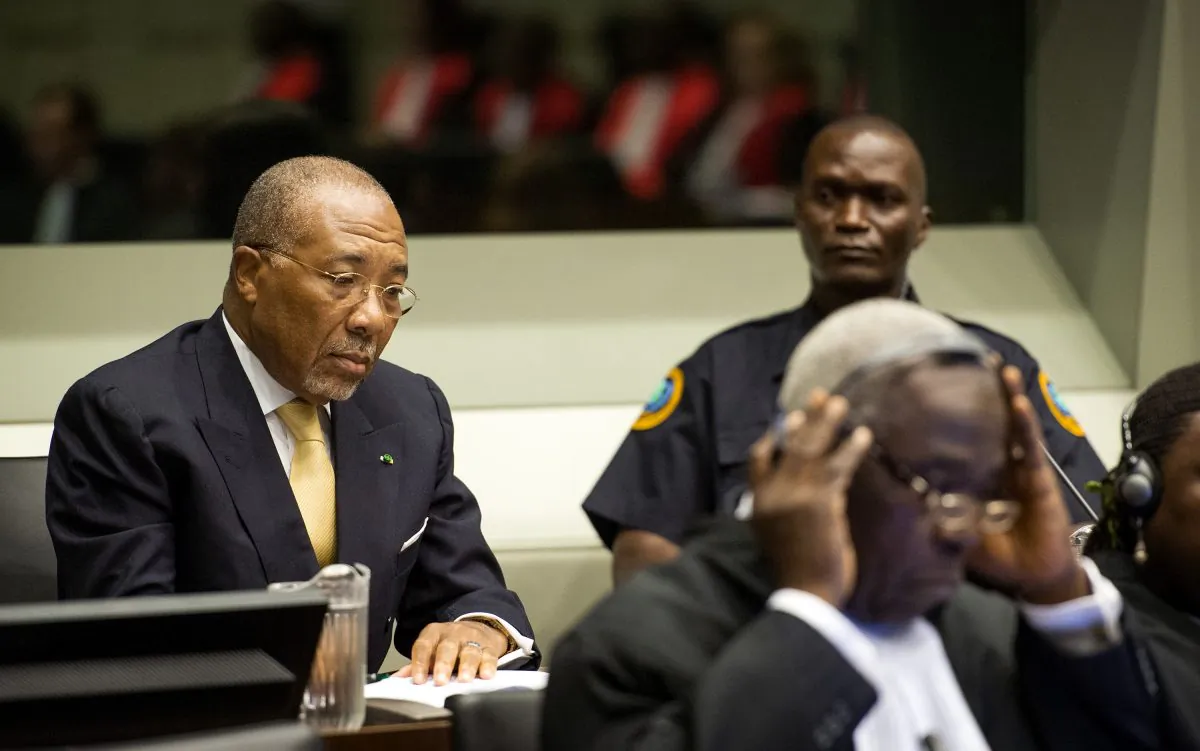 Former Liberian President Charles Taylor, left, waits for the start of his appeal judgement at the Special Court for Sierra Leone (SCSL) in Leidschendam, near The Hague, Netherlands, Thursday Sept. 26, 2013. (AP Photo/Koen van Weel)