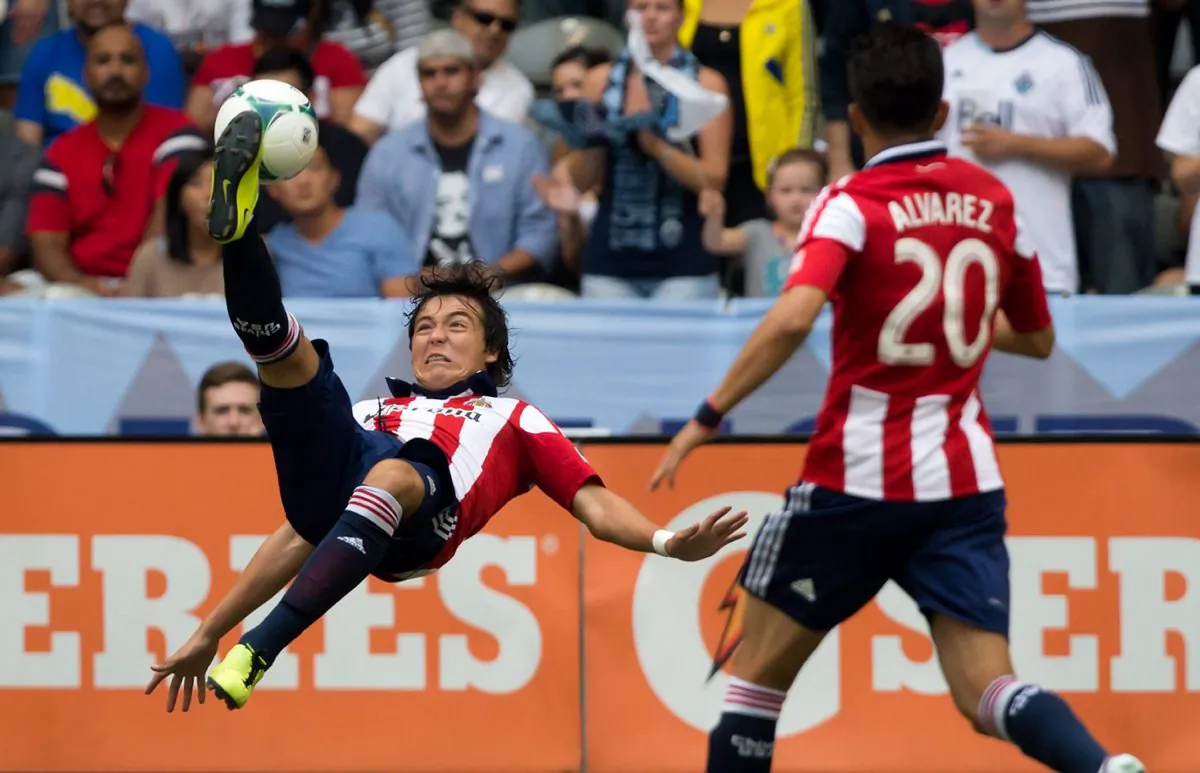Chivas USA's Erick Torres scores a beautiful overhead kick goal against the Vancouver Whitecaps as teammate Carlos Alvarez looks on in MLS action in Vancouver, B.C., on Sept. 1, 2013. (THE CANADIAN PRESS/Darryl Dyck)