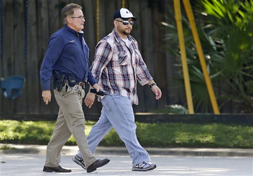 George Zimmerman, right, is escorted to the home of Shellie Zimmerman's parents by a Lake Mary police officer on September 9 in Lake Mary, Florida. (AP Photo/John Raoux)