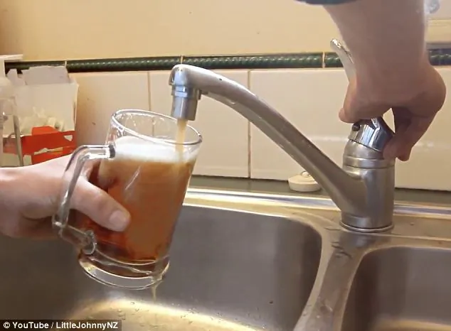 Beer runs from the faucet of an Auckland, New Zealand, home as part of a practical joke. (YouTube)
