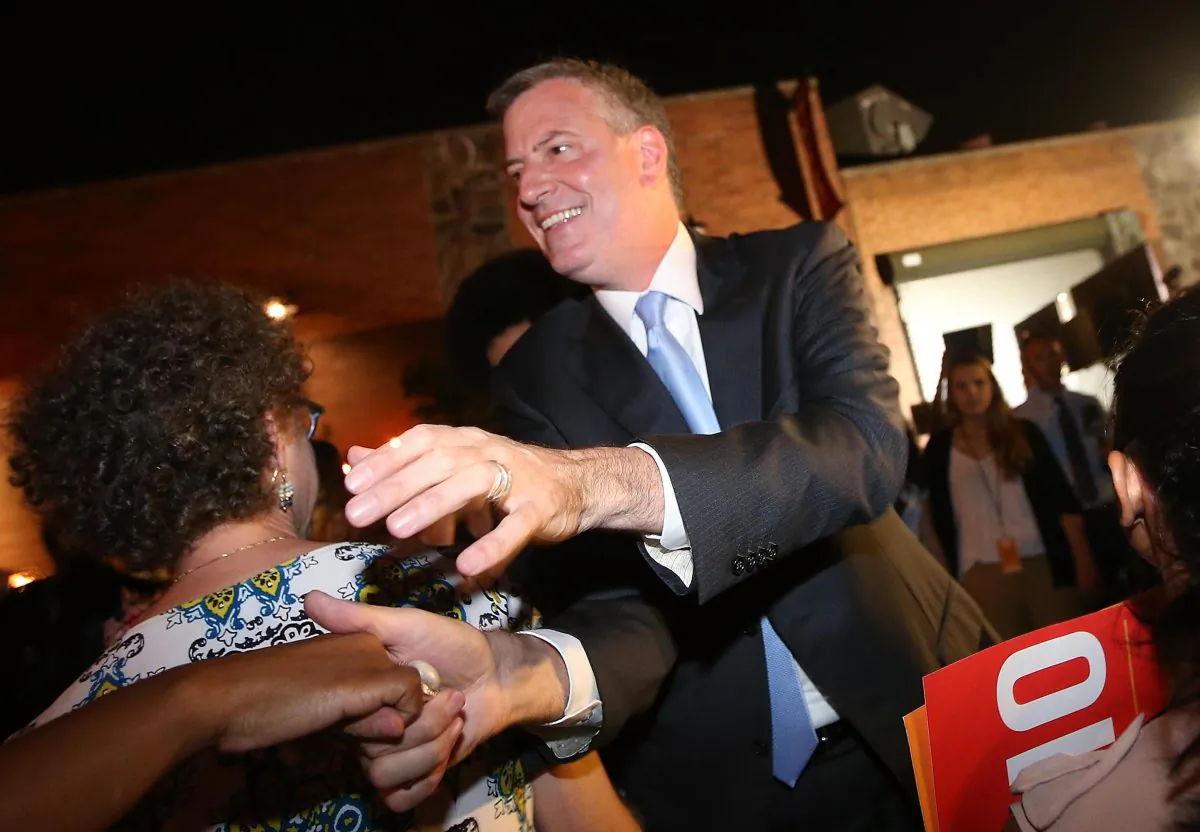 Democratic candidate for mayor and Public Advocate Bill de Blasio (C) greets the crowd while arriving at his primary night party on September 10, 2013, in Brooklyn, New York City. (Mario Tama/Getty Images)