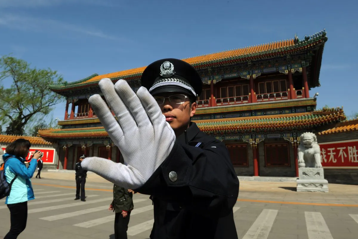 A policeman blocks photos from being taken outside Zhongnanhai, the central headquarters for the Chinese Communist Party, in Beijing, on April 11, 2012. (Mark Ralston/AFP/Getty Images)