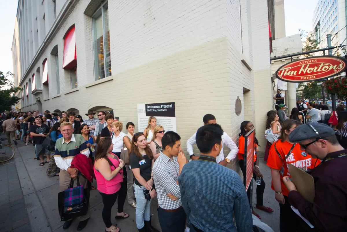 People line up around the block to see a film at Princess of Wales Theatre on Tuesday. Media can skip lines like this and take in special screenings of TIFF films. (Matthew Little/Epoch Times)
