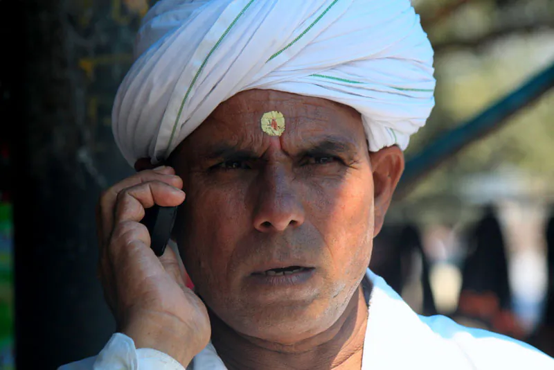 An Indian man talks on his mobile phone in the pilgrim town of Haridwar in Uttrakhand state of India on 11 October 2012. A recent study by research firm Juxt indicated that about 554 million people in Indian own mobile phones. (VENUS UPADHAYAYA/EPOCH TIMES)
