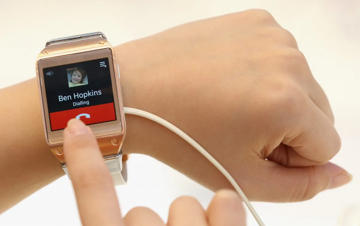 Visitors try out the new Galaxy Gear smartwatch at the Samsung stand at the IFA 2013 consumer electronics trade fair on Sept. 5 in Berlin, Germany. (Sean Gallup/Getty Images)